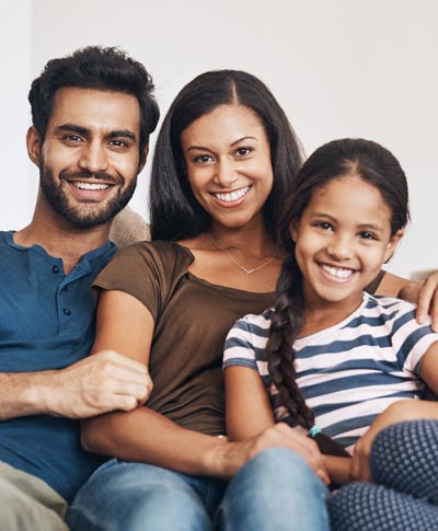 smiling family of three