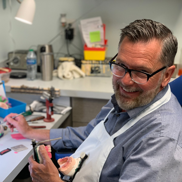 man working on dentures