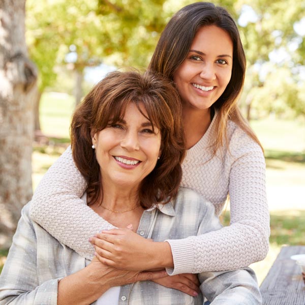 mother and adult daughter smiling