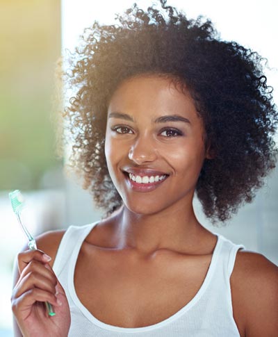smiling woman with toothbrush