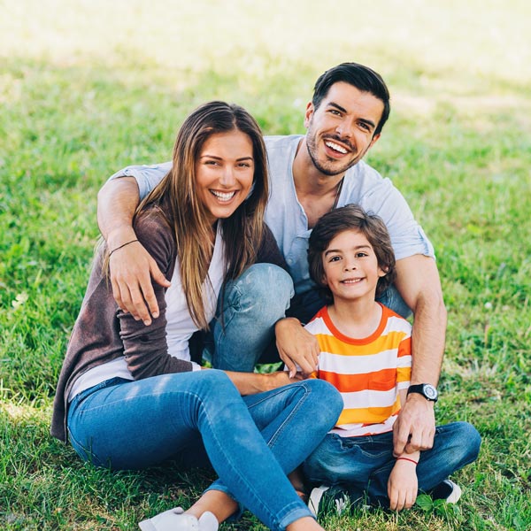 smiling family of three